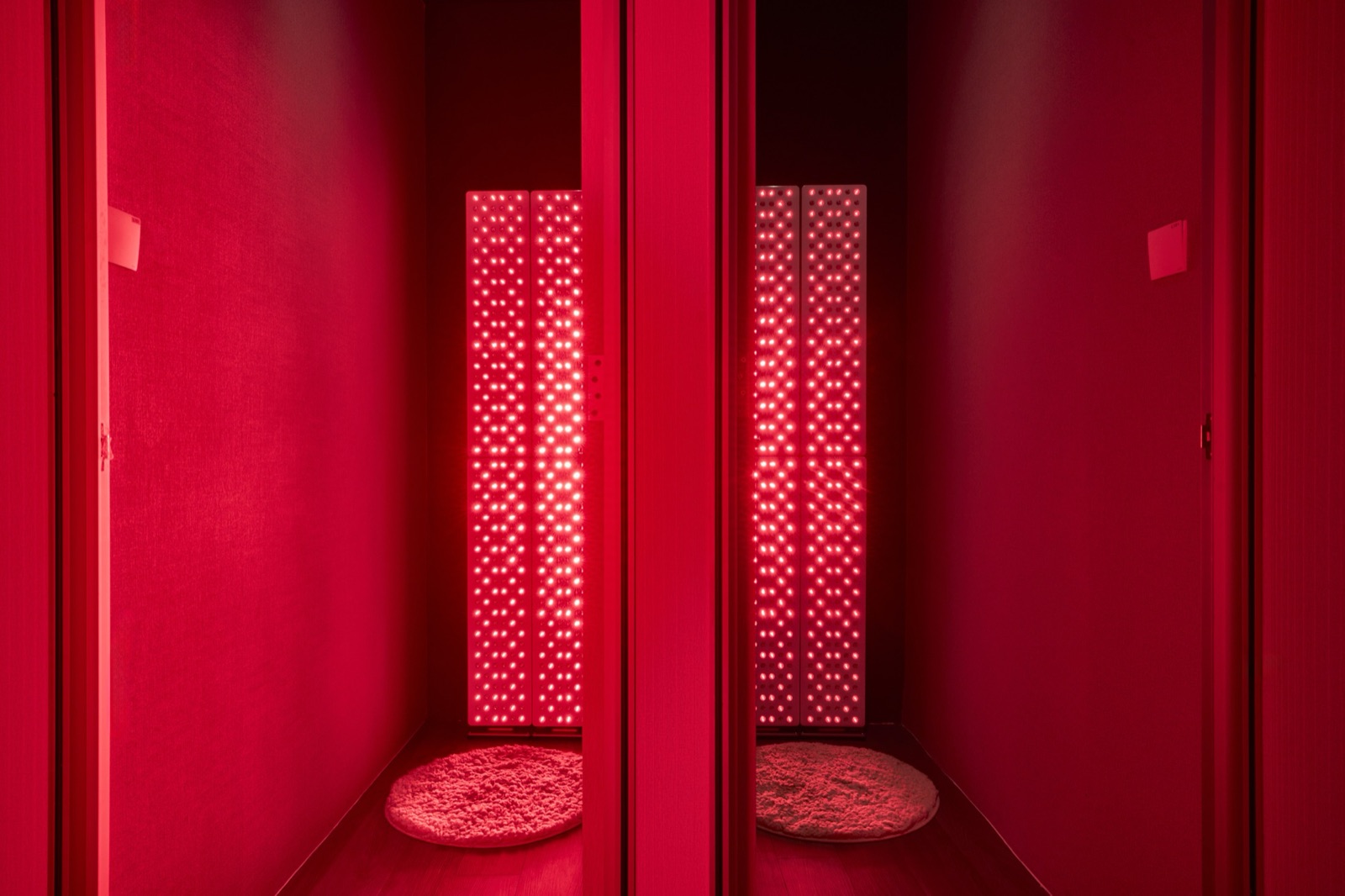 House Longevity red light room with two full-body Joovv panels lit